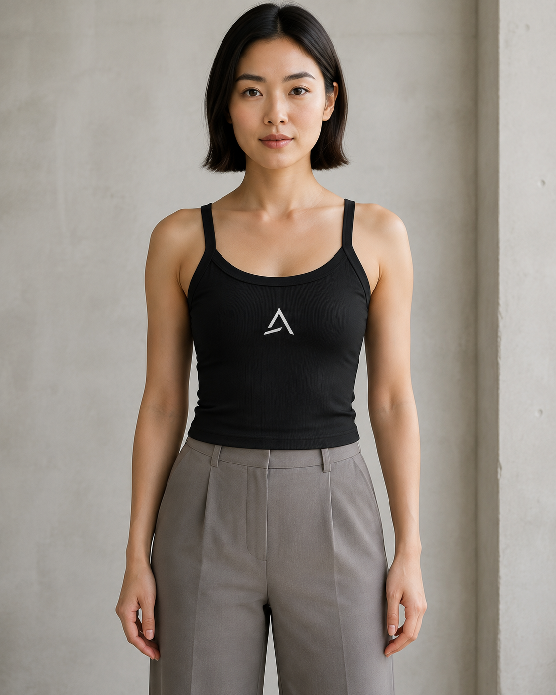 Self Made Club Form Rib Tank in black on a female model, showing narrow flat straps, scoop neckline, micro-rib fabric and centered embroidered mark. AI-generated styling visualization.