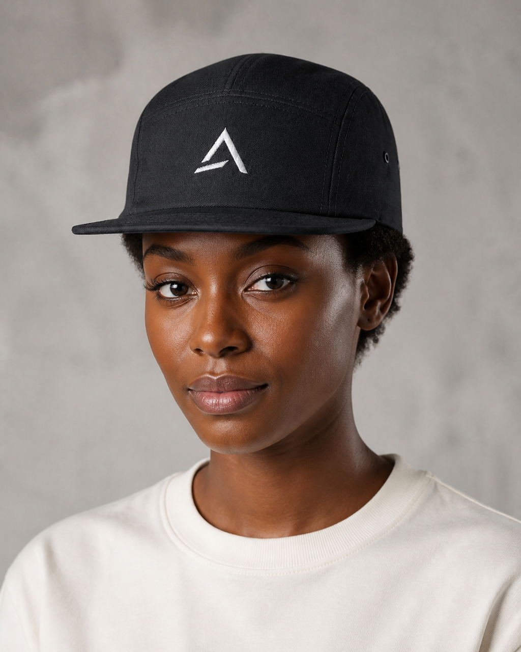Self Made Club 5-Panel Camp Cap in black on an alternate female model, three-quarter studio view. AI-generated styling visualization.