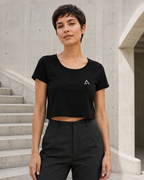 Self Made Club Crop Tee in black with a small white chest mark on an alternate female model, full untucked front view. AI-generated styling visualization.