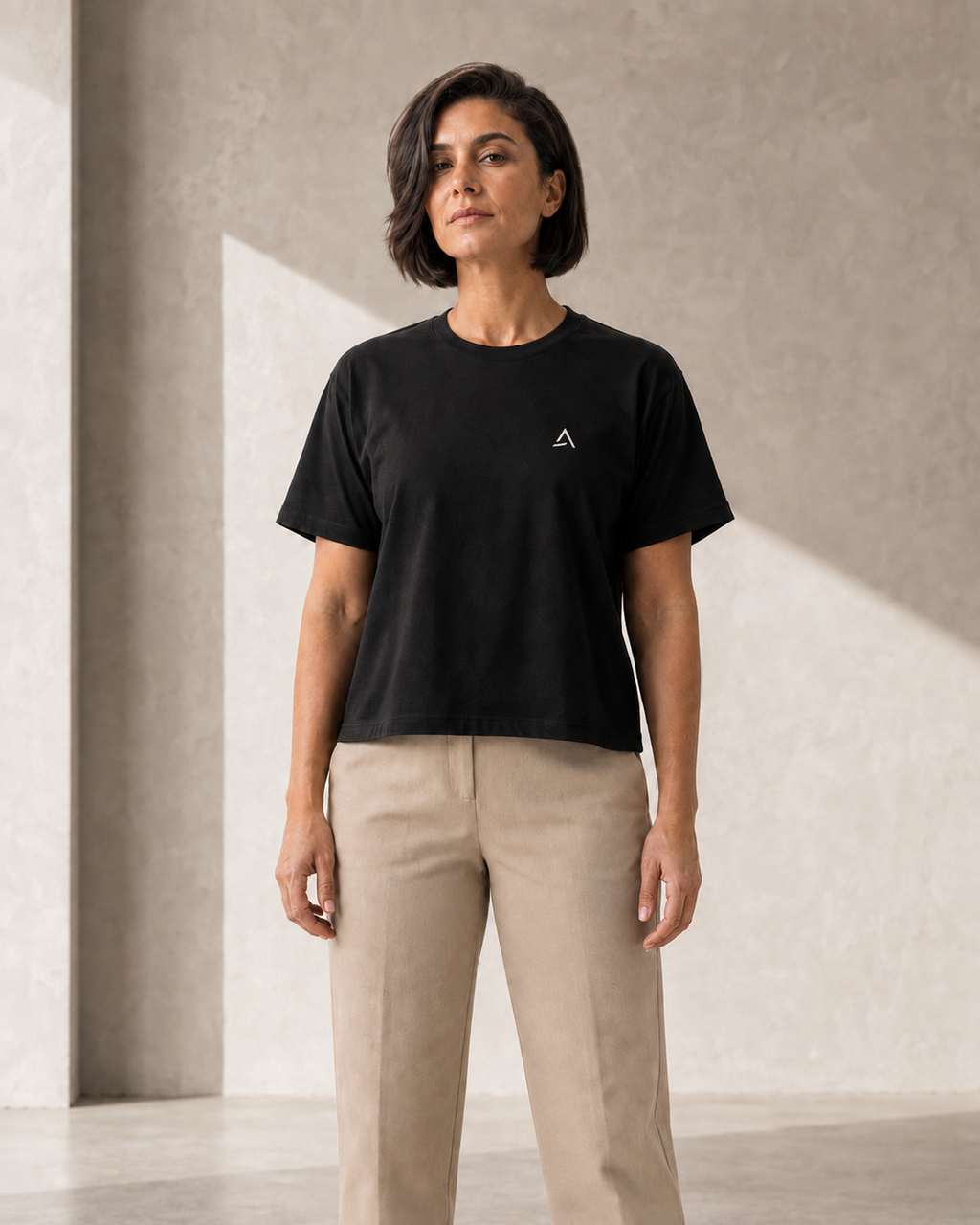 Self Made Club Form Box Tee in black on an alternate female model, full untucked front view showing the small left chest embroidery and boxy fit. AI-generated styling visualization.