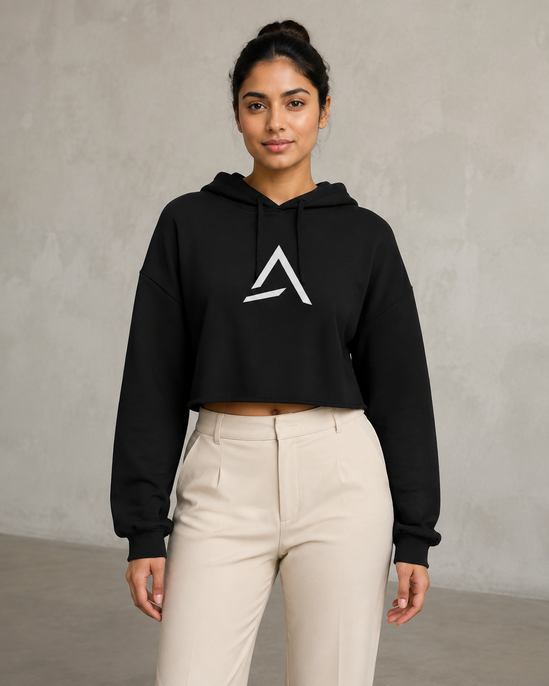 Self Made Club Form Crop Hoodie in black on a female model in front view, showing center chest mark, raw cropped hem and relaxed fit. AI-generated styling visualization.
