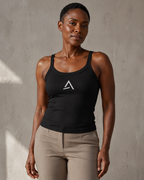 Self Made Club Form Rib Tank in black on a different female model, showing narrow flat straps, scoop neckline, micro-rib fabric and centered embroidered mark. AI-generated styling visualization.