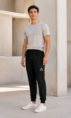 Self Made Club Joggers in black on an alternate male model, standing three-quarter view showing full length and ankle cuffs. AI-generated styling visualization.