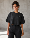 Self Made Club Washed Form Crop in black on a female model in front view, showing left chest mark, washed black cotton and oversized cropped fit. AI-generated styling visualization.