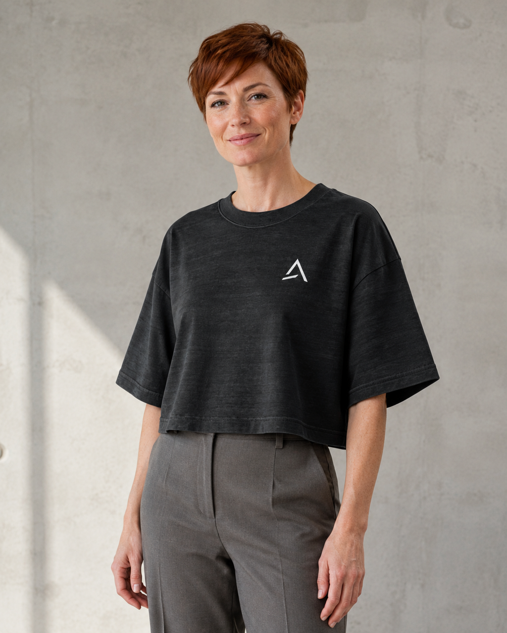 Self Made Club Washed Form Crop in black on a different female model in three-quarter view, showing left chest mark, washed black cotton and oversized cropped fit. AI-generated styling visualization.
